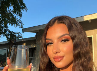 a woman holding a glass of wine, Quinta das Queimas